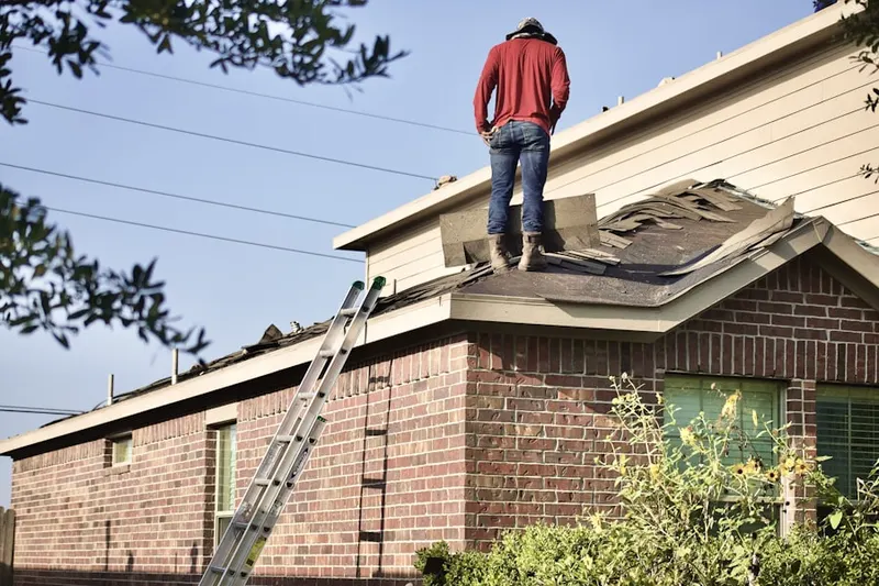 Professional roofer working on a residential roof in Downtown Rosemount